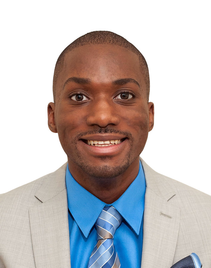 Derrick Tuff smiling in a gray suit and blue shirt